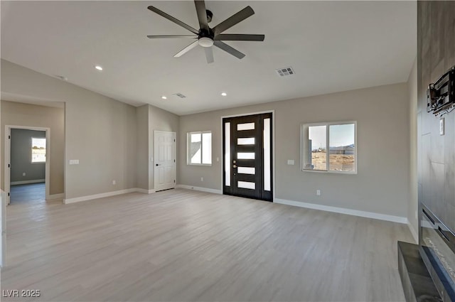 unfurnished living room with recessed lighting, light wood-style floors, vaulted ceiling, ceiling fan, and baseboards