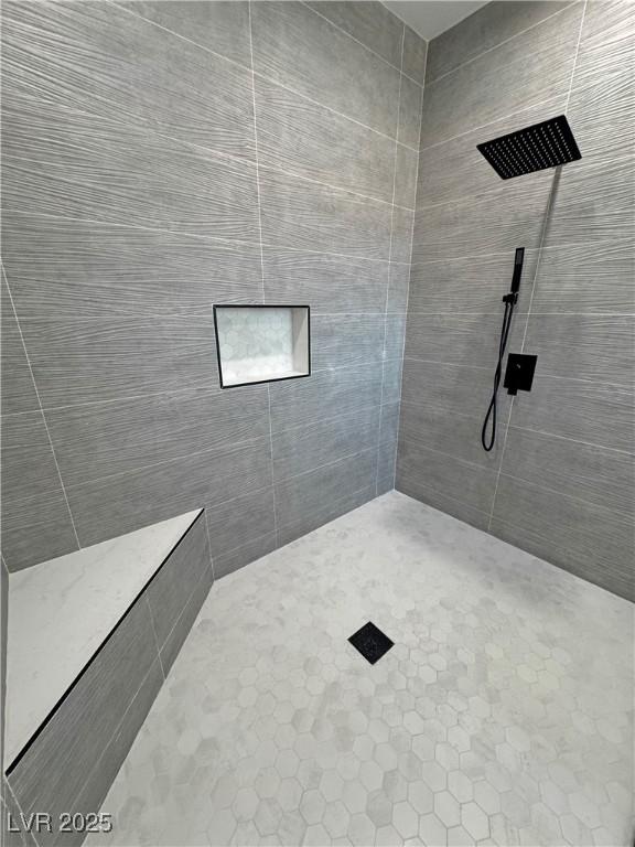 bathroom with a tile shower