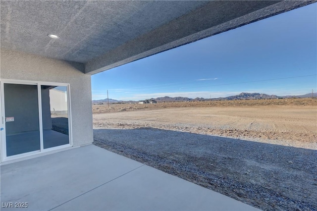 view of patio / terrace with a mountain view