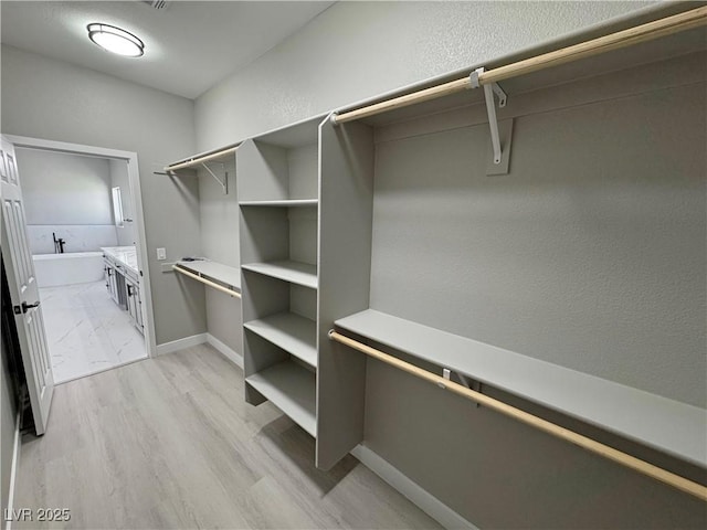 walk in closet featuring light wood-type flooring