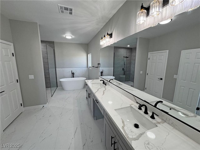 full bath with marble finish floor, double vanity, a soaking tub, visible vents, and walk in shower