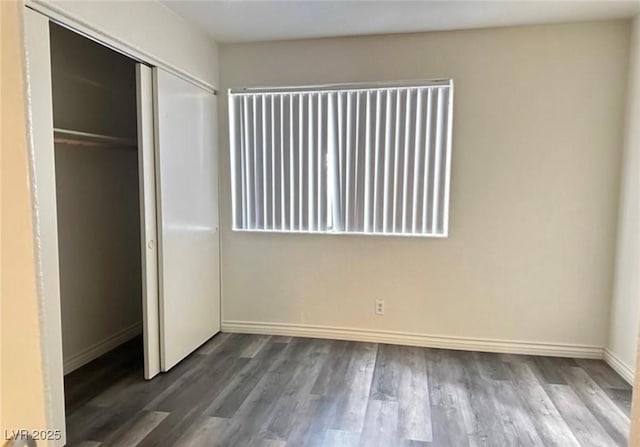 unfurnished bedroom with wood-type flooring and a closet