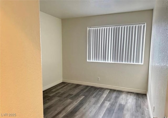 unfurnished room featuring dark hardwood / wood-style floors