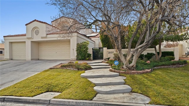 mediterranean / spanish-style house with a garage and a front lawn