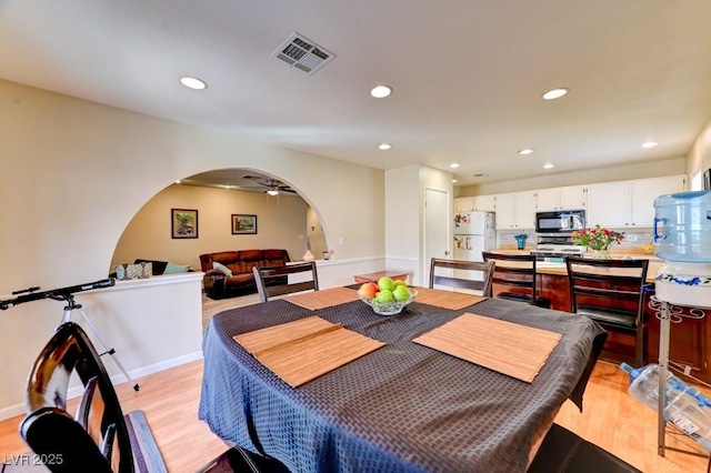 dining area with ceiling fan and light hardwood / wood-style floors