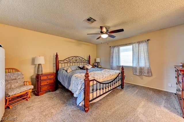 carpeted bedroom with a textured ceiling and ceiling fan