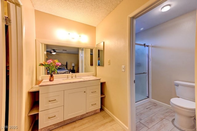 bathroom with hardwood / wood-style flooring, vanity, an enclosed shower, toilet, and a textured ceiling