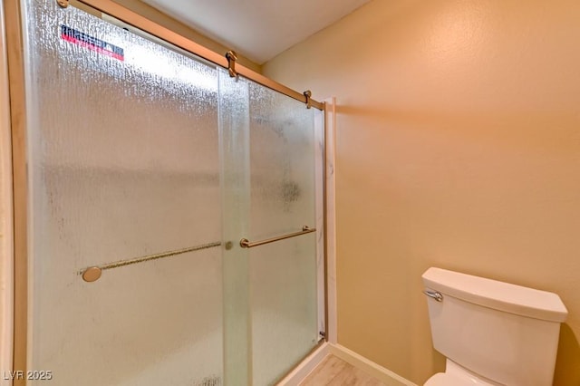 bathroom featuring toilet and walk in shower