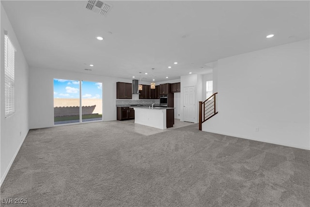 unfurnished living room with sink and light carpet