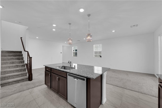 kitchen featuring light carpet, sink, stainless steel dishwasher, and an island with sink