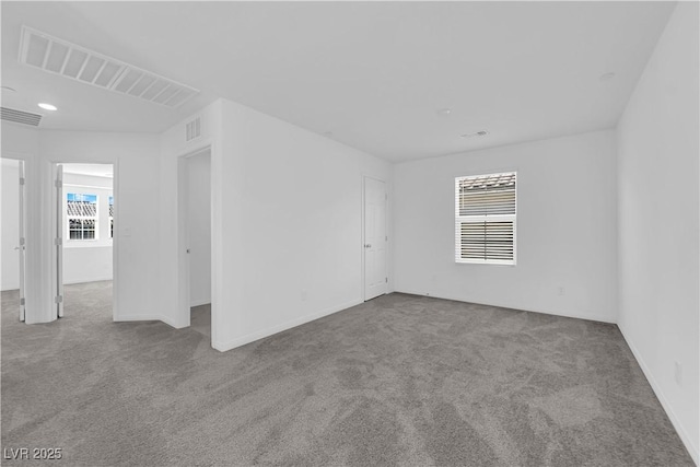 unfurnished room featuring light colored carpet