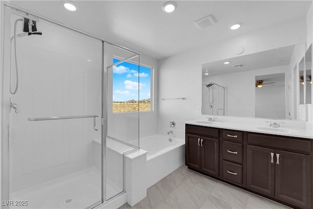 bathroom with ceiling fan, vanity, and independent shower and bath