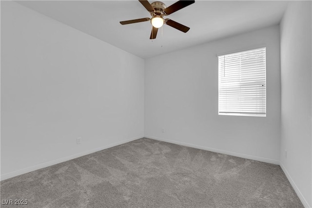 empty room featuring ceiling fan and light carpet