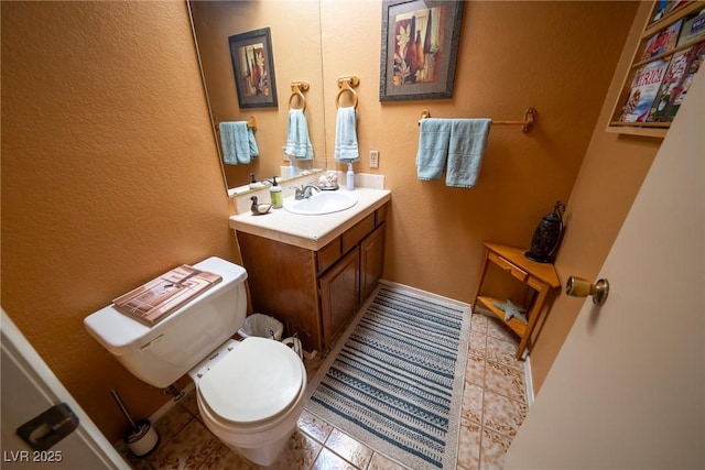 bathroom with tile patterned floors, vanity, and toilet