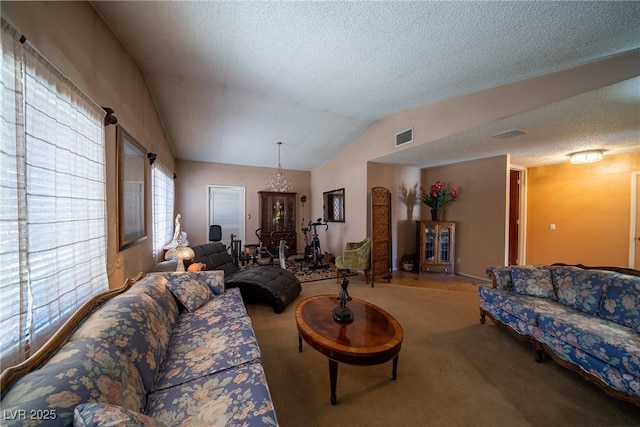 living room featuring vaulted ceiling, light carpet, and a textured ceiling