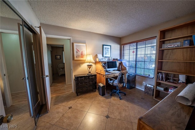 office space with light tile patterned flooring and a textured ceiling