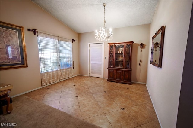 unfurnished dining area with a notable chandelier, lofted ceiling, a textured ceiling, and light tile patterned floors