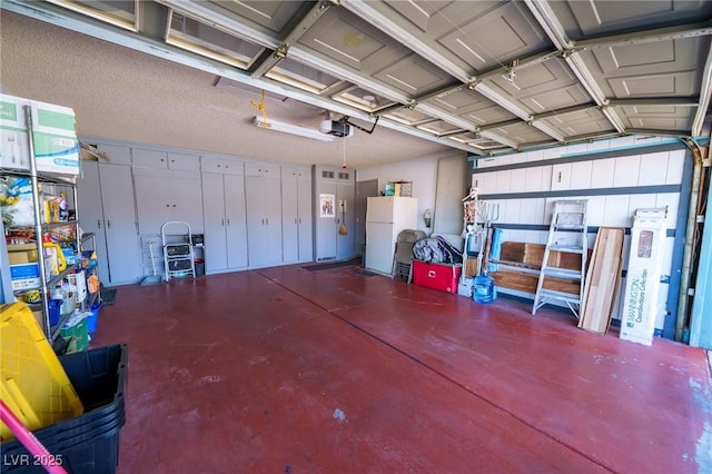 garage with white refrigerator and a garage door opener