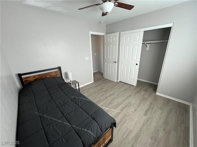 bedroom featuring ceiling fan, a closet, and light wood-type flooring