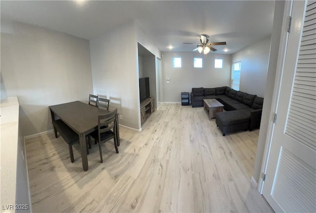 living room with ceiling fan and light wood-type flooring