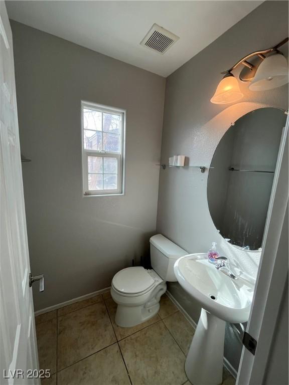 bathroom with tile patterned flooring and toilet