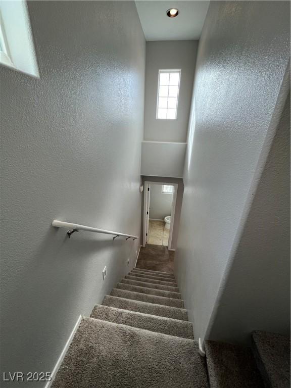 stairway featuring a high ceiling