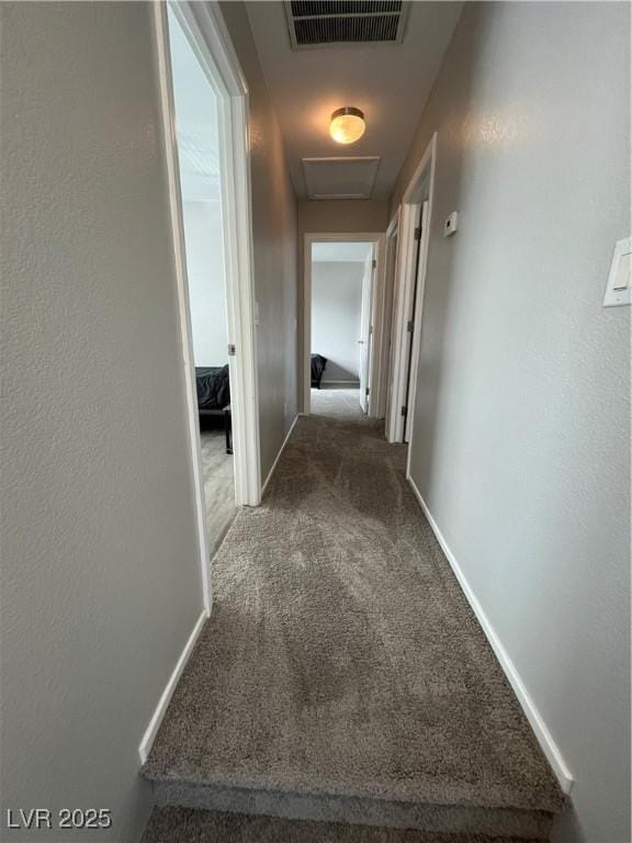 corridor featuring dark carpet