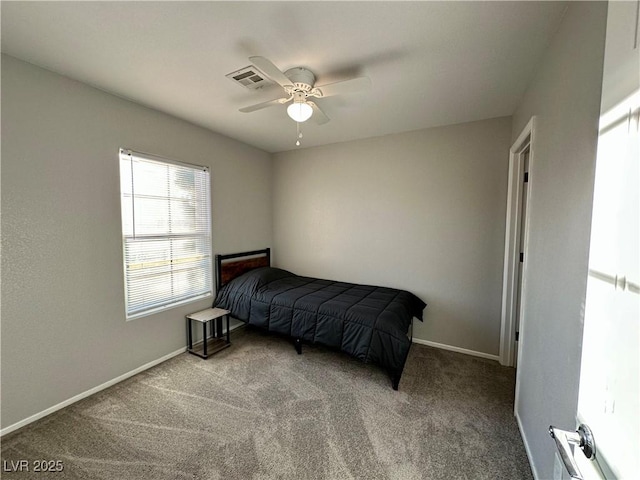 carpeted bedroom with a ceiling fan, visible vents, and baseboards