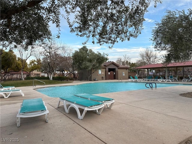 pool featuring fence and a patio