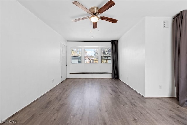 spare room featuring ceiling fan and light hardwood / wood-style flooring