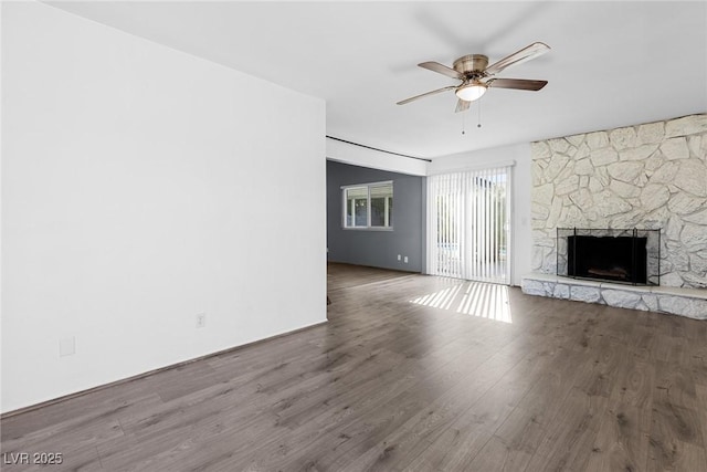 unfurnished living room with ceiling fan, wood-type flooring, and a fireplace