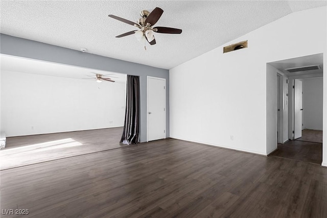 empty room with vaulted ceiling, ceiling fan, a textured ceiling, and dark hardwood / wood-style flooring