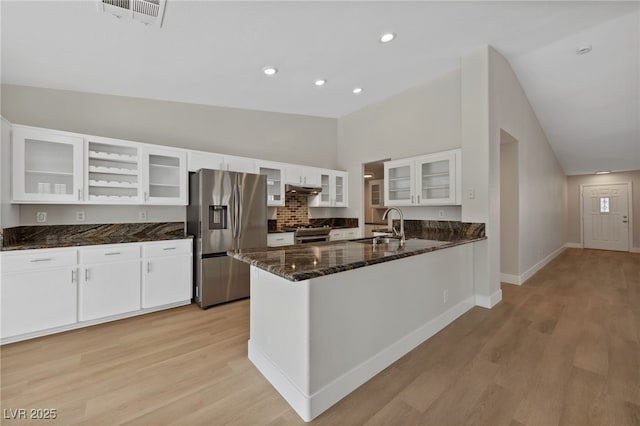 kitchen featuring white cabinetry, sink, dark stone counters, kitchen peninsula, and stainless steel appliances