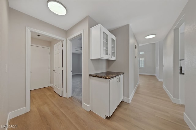 corridor with light hardwood / wood-style floors