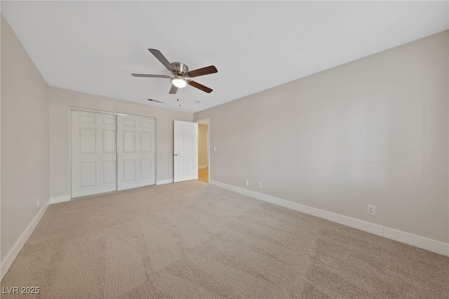 unfurnished bedroom with light carpet, a closet, and ceiling fan