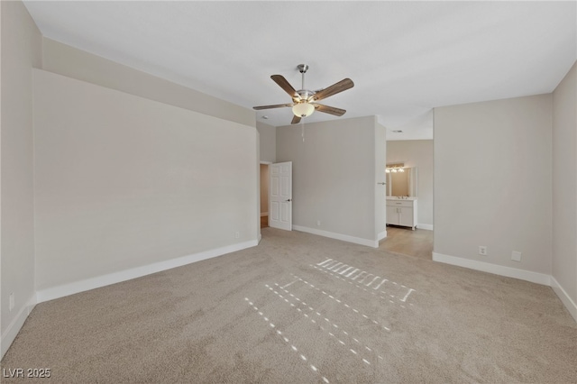 carpeted empty room featuring ceiling fan