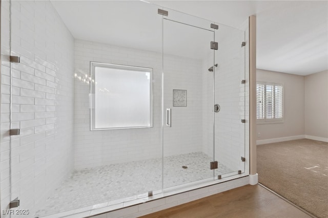 bathroom with an enclosed shower and hardwood / wood-style flooring