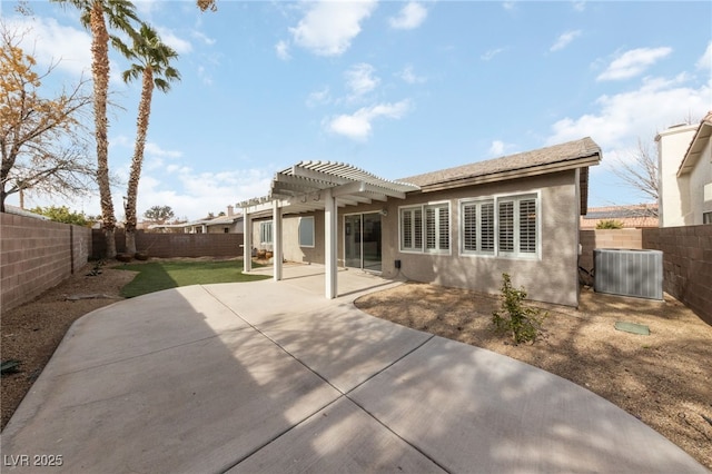 rear view of property with cooling unit, a pergola, and a patio area