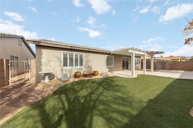 rear view of house with a patio, a yard, and a pergola