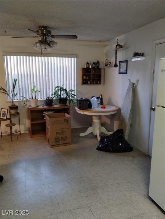 dining room with ceiling fan and a textured ceiling