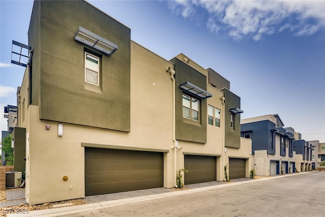 contemporary house featuring a garage and central AC