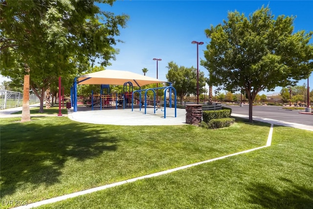 view of home's community featuring a playground and a lawn