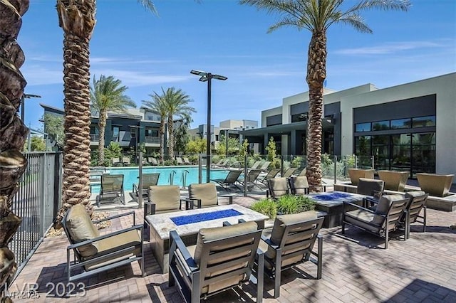 view of pool featuring an outdoor fire pit and a patio