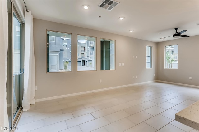 unfurnished room featuring ceiling fan and light tile patterned floors