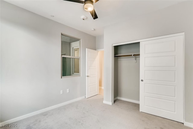 unfurnished bedroom featuring light colored carpet, ceiling fan, and a closet