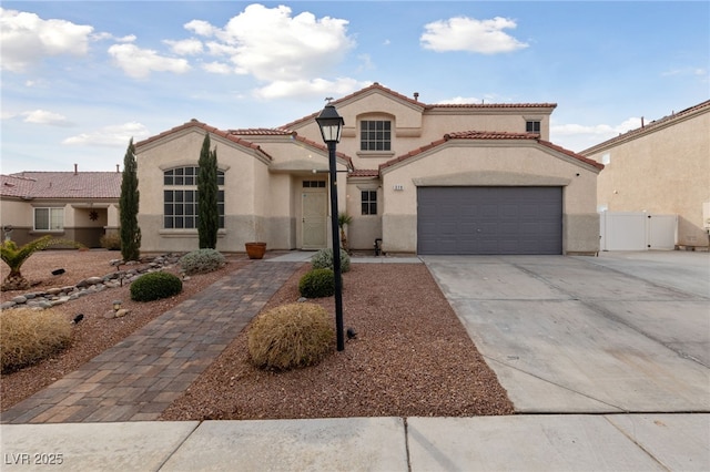 mediterranean / spanish-style house with a garage