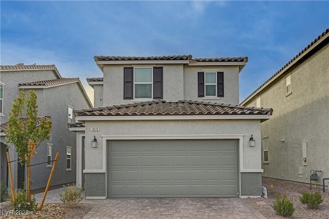 mediterranean / spanish-style house with a garage