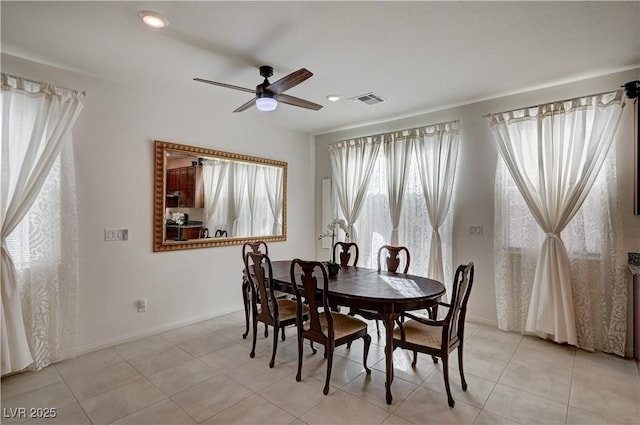 tiled dining space with ceiling fan