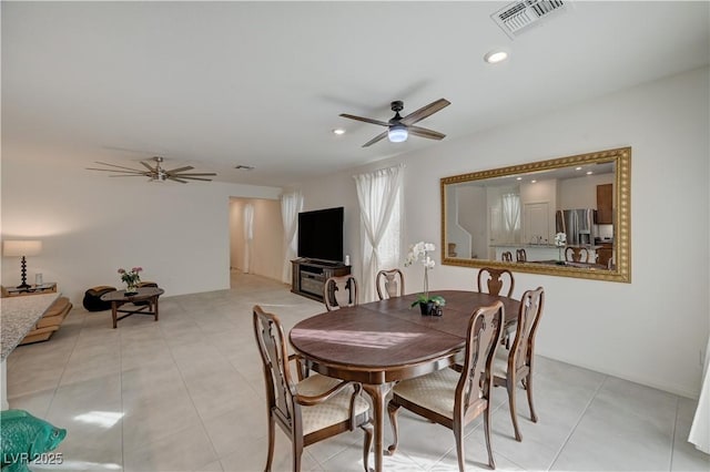 dining space with light tile patterned floors and ceiling fan