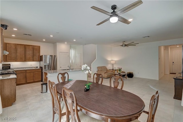 dining room with ceiling fan and light tile patterned floors